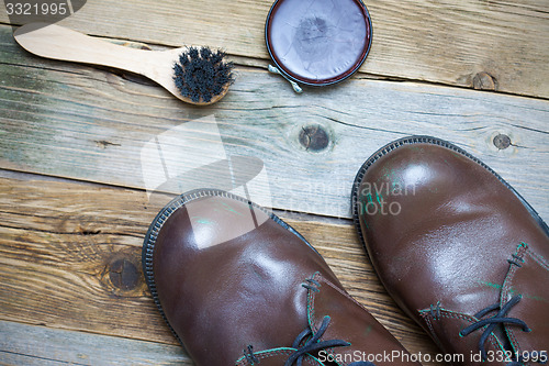 Image of Still life with brown boots, shoe polish and shoe brush