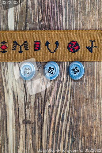 Image of vintage tape with embroidered ornaments and old buttons