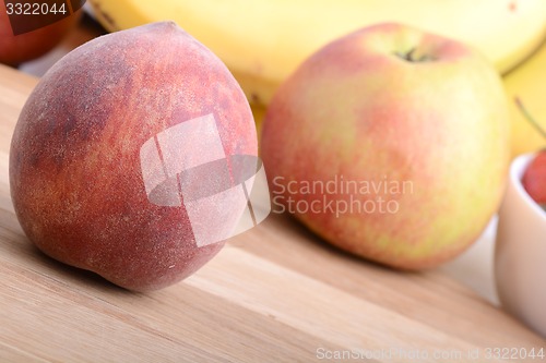 Image of fruits on wodden table, peach, apple, bananas, food concept