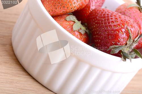 Image of Close up strawberry on wooden plate