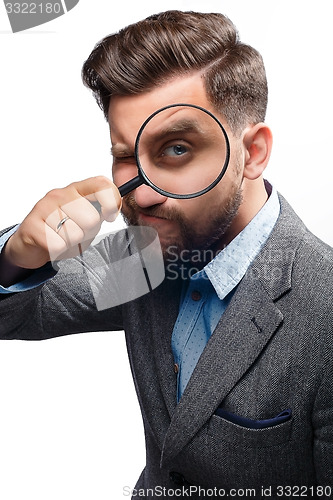 Image of Man with magnifying glass on white background