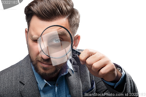 Image of Man with magnifying glass on white background