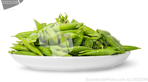 Image of Pile of green peas in pods on white plate