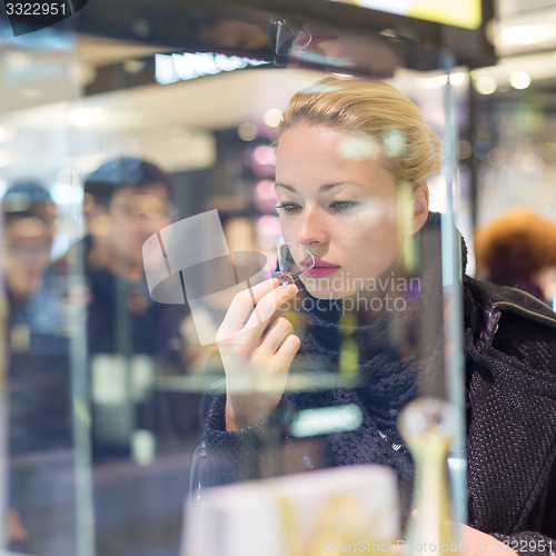 Image of Beautiful woman shopping in beauty store.