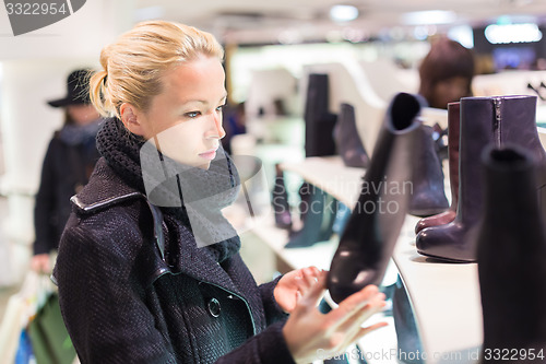 Image of Beautiful woman shopping in shoe store.