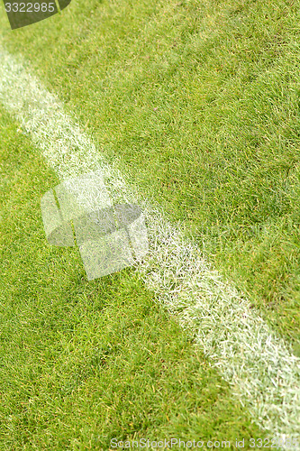 Image of White stripe on the green soccer field from top view