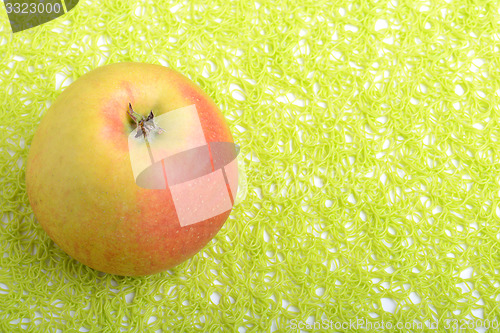 Image of fresh apple on green background