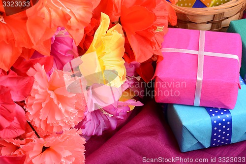 Image of present gift box and flower bouquet on silk