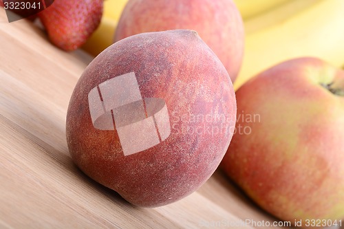 Image of fruits on wooden table, peach, apple, bananas, food concept