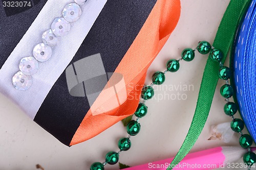 Image of Office table with ribbons, pencils and pearls