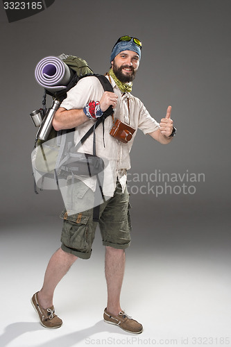 Image of Full length portrait of a male fully equipped tourist 