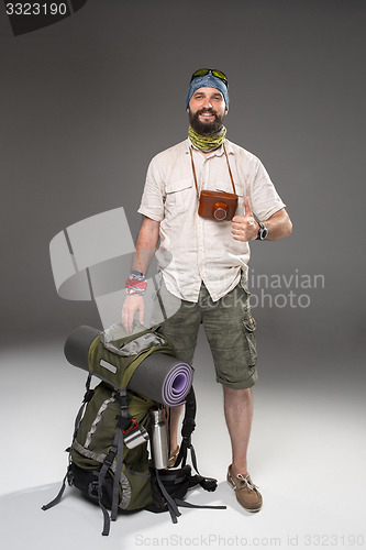 Image of Full length portrait of a male fully equipped tourist 