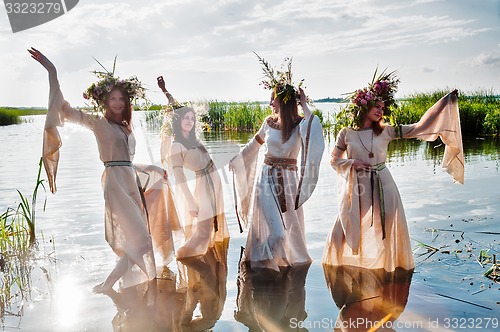 Image of Pretty women with flower wreath in water