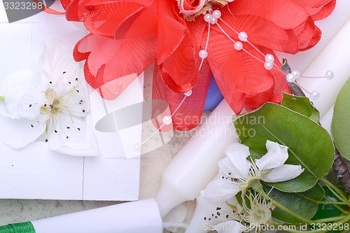 Image of Office table with flower, ribbons, pencil, candles