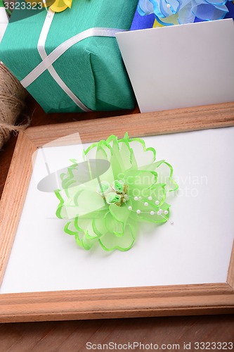 Image of Valentine frame with flowers, gift boxes and empty wooden frame