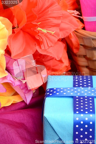 Image of present gift box and flower bouquet on silk