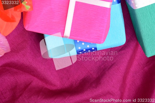 Image of present gift box and flower bouquet on silk