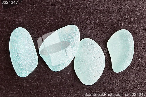 Image of four blue glass pieces polished by the sea