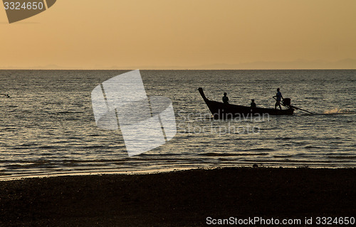 Image of Silhouette of Long tail boat  in Railay Beach Thailand at sunset