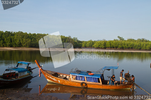 Image of  Long tail boat  Thailand waiting at the beach