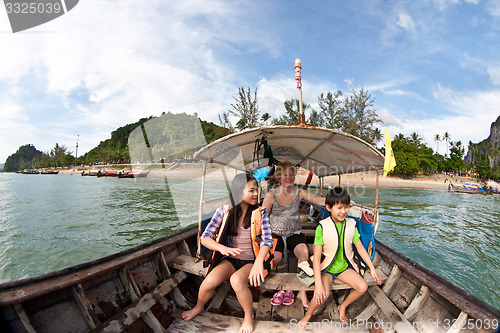 Image of Family on a Long tail boat  in Railay Beach Thailand