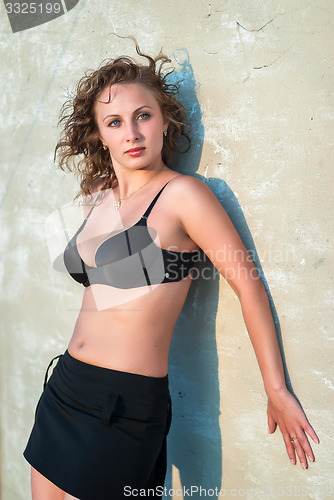 Image of Pretty woman relaxed at wall