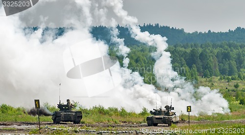 Image of Military tanks hide behind smoke screen