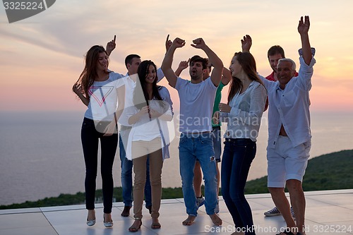 Image of party people  on sunset