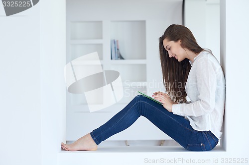 Image of woman at home using tablet