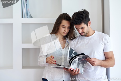 Image of relaxed young couple at home staircase
