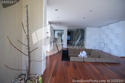 Image of Portrait of senior man relaxing in sofa