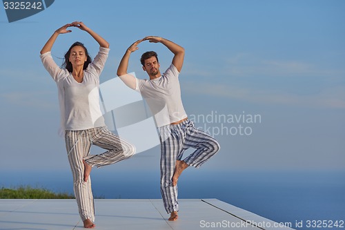 Image of young couple practicing yoga
