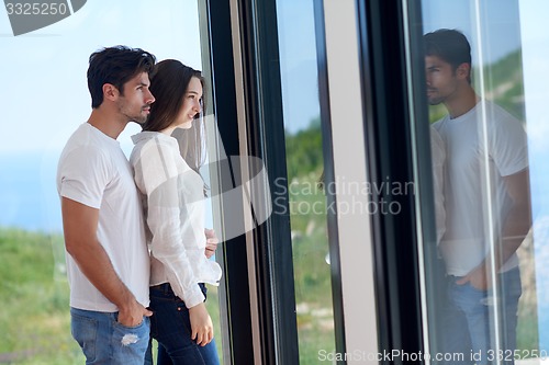 Image of relaxed young couple at home staircase