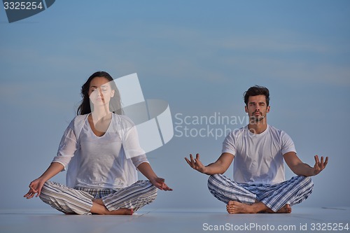 Image of young couple practicing yoga