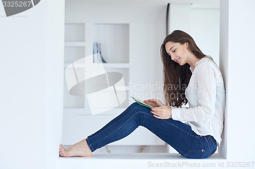 Image of woman at home using tablet