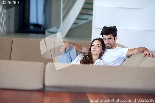 Image of relaxed young couple at home staircase