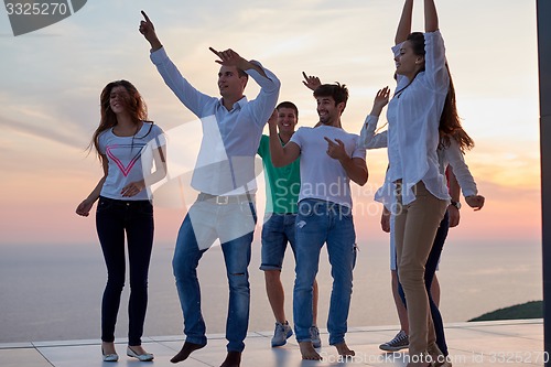 Image of party people  on sunset