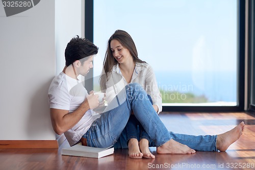 Image of relaxed young couple at home staircase