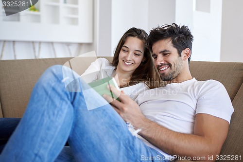 Image of couple at modern home using tablet computer