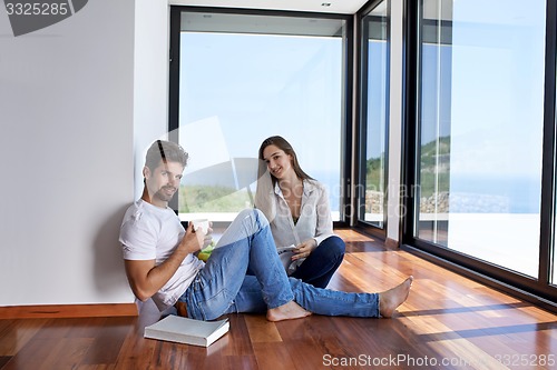 Image of relaxed young couple at home staircase