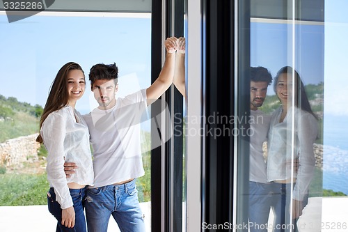 Image of relaxed young couple at home staircase