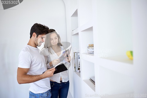 Image of relaxed young couple at home staircase