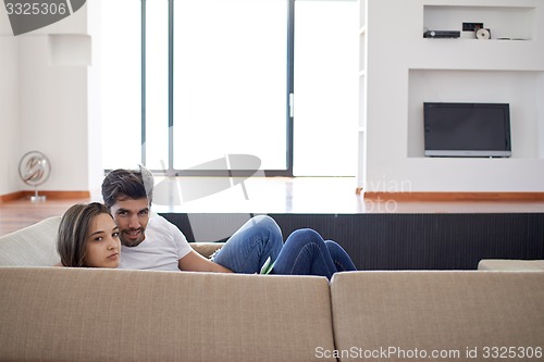 Image of relaxed young couple at home staircase