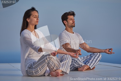 Image of young couple practicing yoga