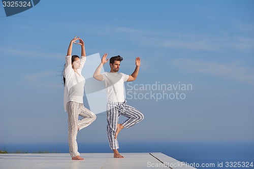 Image of young couple practicing yoga