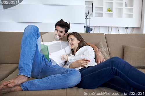 Image of couple at modern home using tablet computer