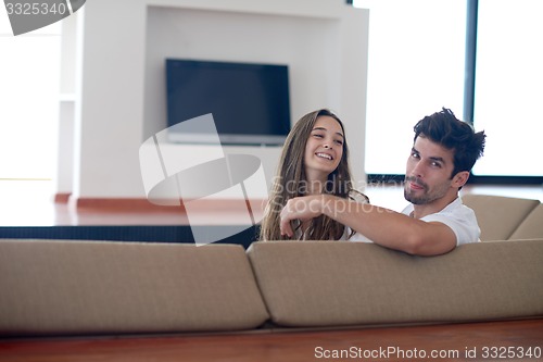 Image of relaxed young couple at home staircase