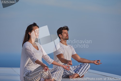 Image of young couple practicing yoga