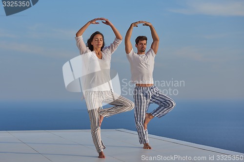 Image of young couple practicing yoga