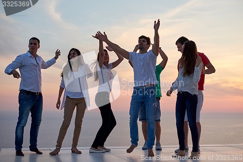 Image of party people  on sunset